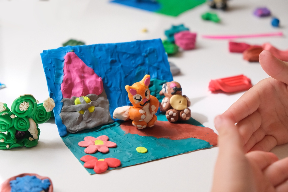 Child,Smearing,Colorful,Plasticine,On,Cardboard,And,Creating,Fairy,Tale